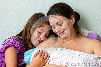 Mother And Daughter Adore Newborn Stock Photo